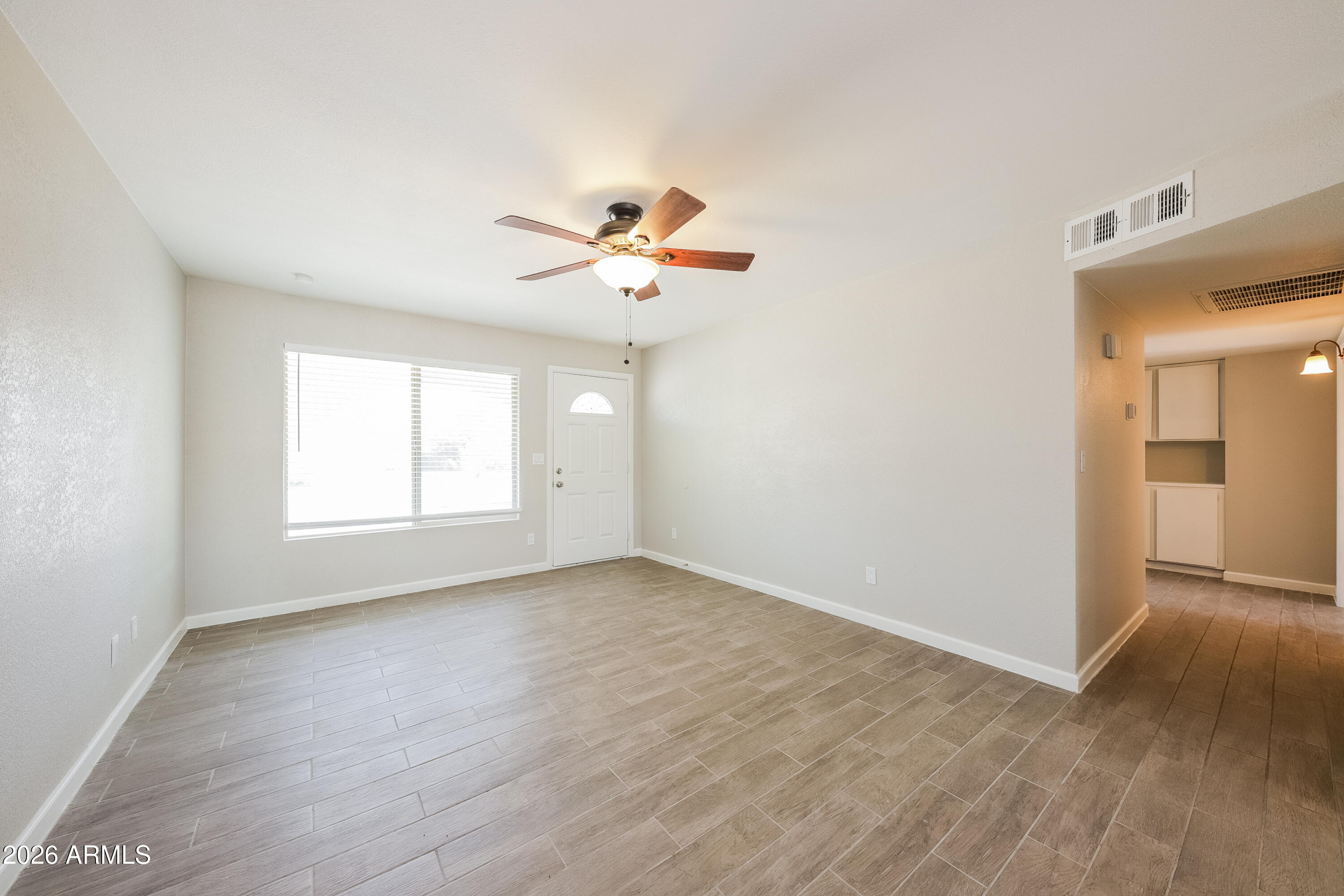 2501 East Villa Rita Drive Phoenix, AZ 85032 - Photo 11 of 15 an empty room with a window and a ceiling fan