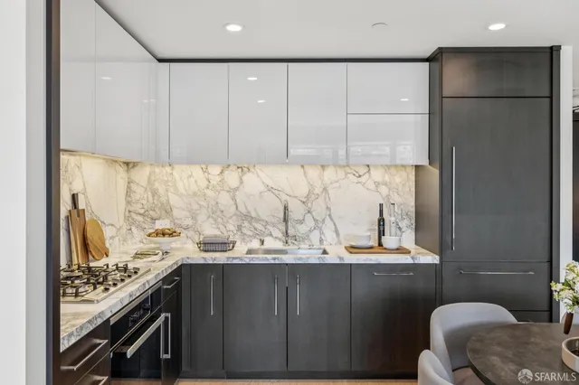 a kitchen with a refrigerator and a stove