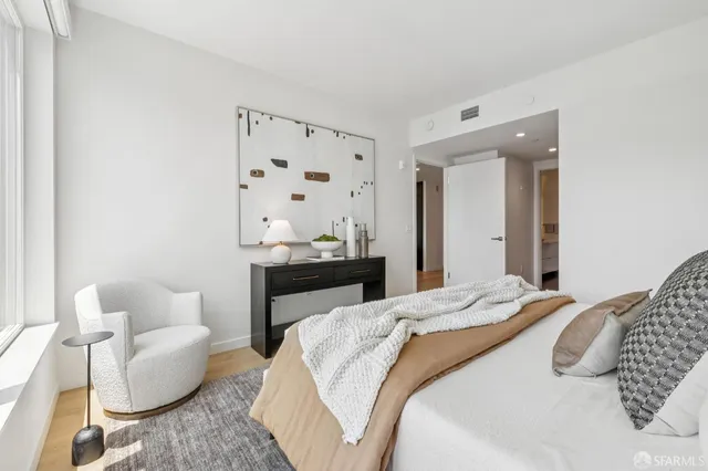 a bedroom with a bed couch and window