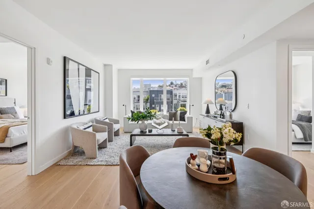 a living room with furniture couches and a large window