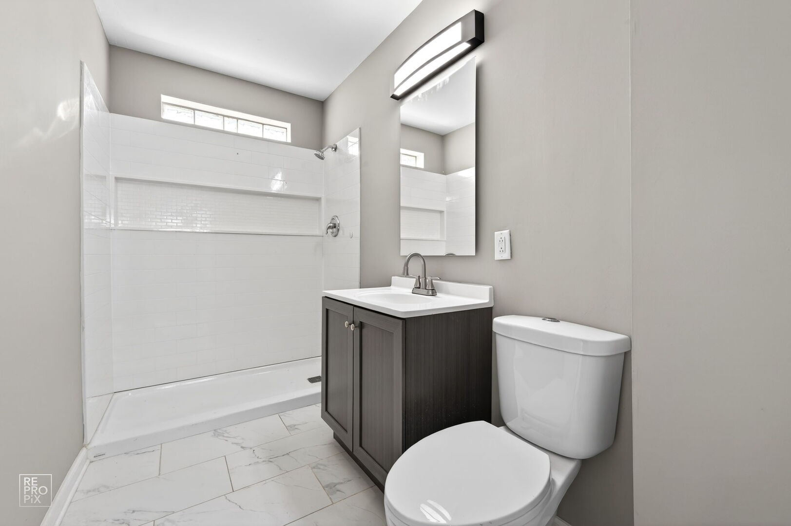 4680 West 83rd Street Chicago, IL 60652 - Photo 5 of 22 a bathroom with a toilet sink vanity and mirror