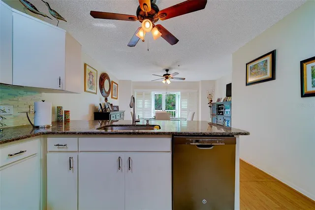 a view of a dining room with furniture wooden floor and chandelier