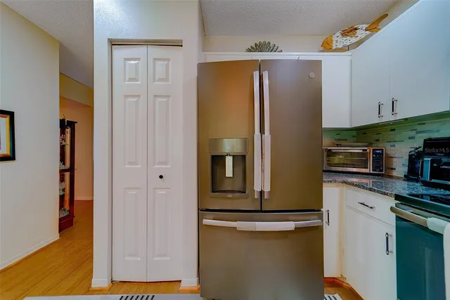 a spacious bedroom with a bed and a lamp with window