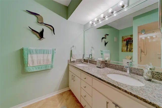 a bedroom with a bed and a flat tv screen on the dresser