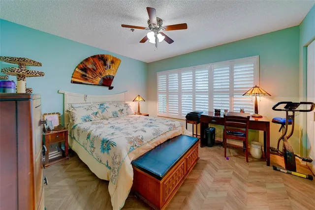 a bathroom with a granite countertop sink a toilet and a shower curtain