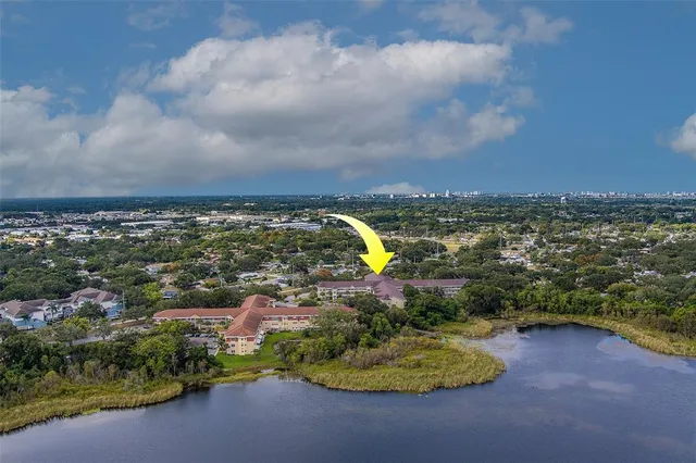 an aerial view of residential building and lake