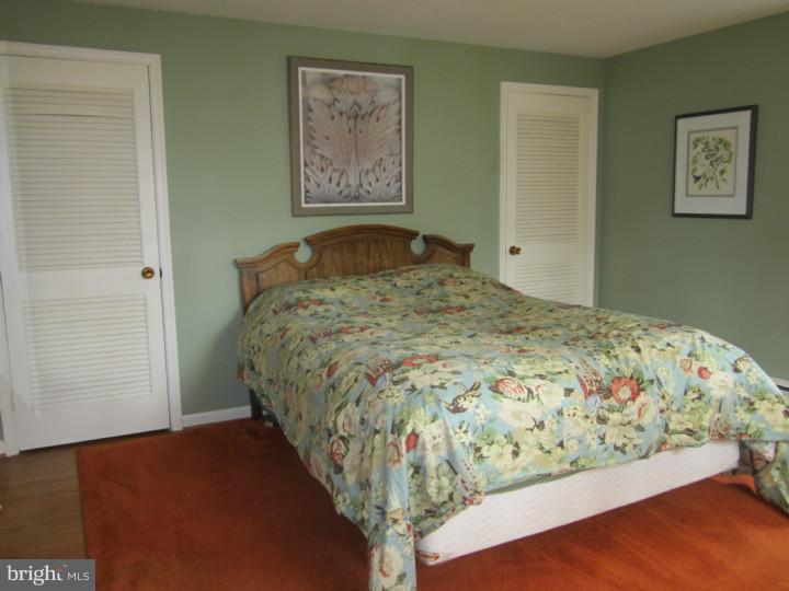 204 Beatty Road Media, PA 19063 - Photo 14 of 19 a bed sitting in a bedroom next to a bathroom