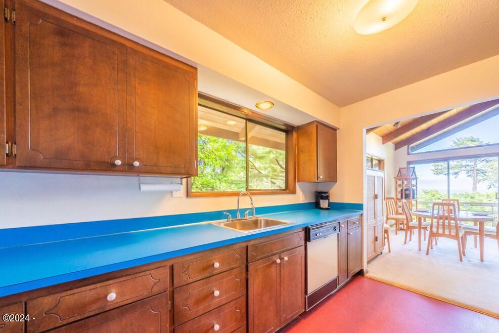 114 Ridge Crest Road Gleneden Beach, OR 97388 - Photo 15 of 40 a kitchen with granite countertop a sink and a white cabinets