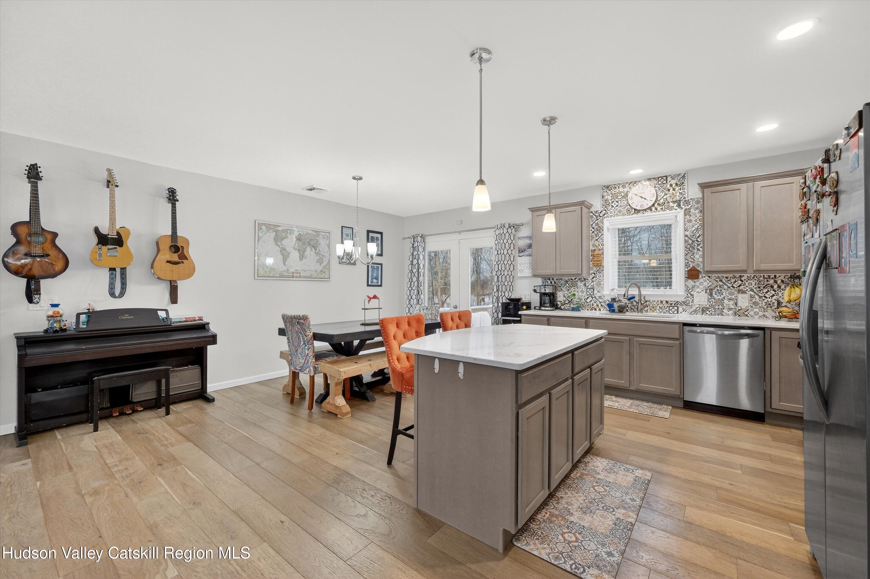 5 3rd Street Milton, NY 12547 - Photo 11 of 31 a kitchen with kitchen island granite countertop a sink a counter top space and stainless steel appliances