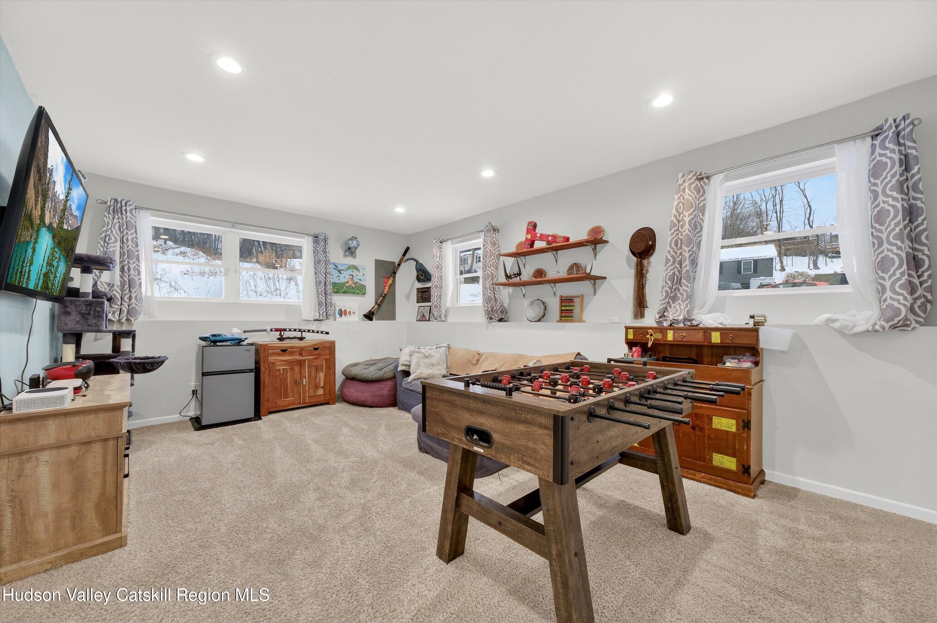 5 3rd Street Milton, NY 12547 - Photo 19 of 31 a living room with furniture a flat screen tv and a window