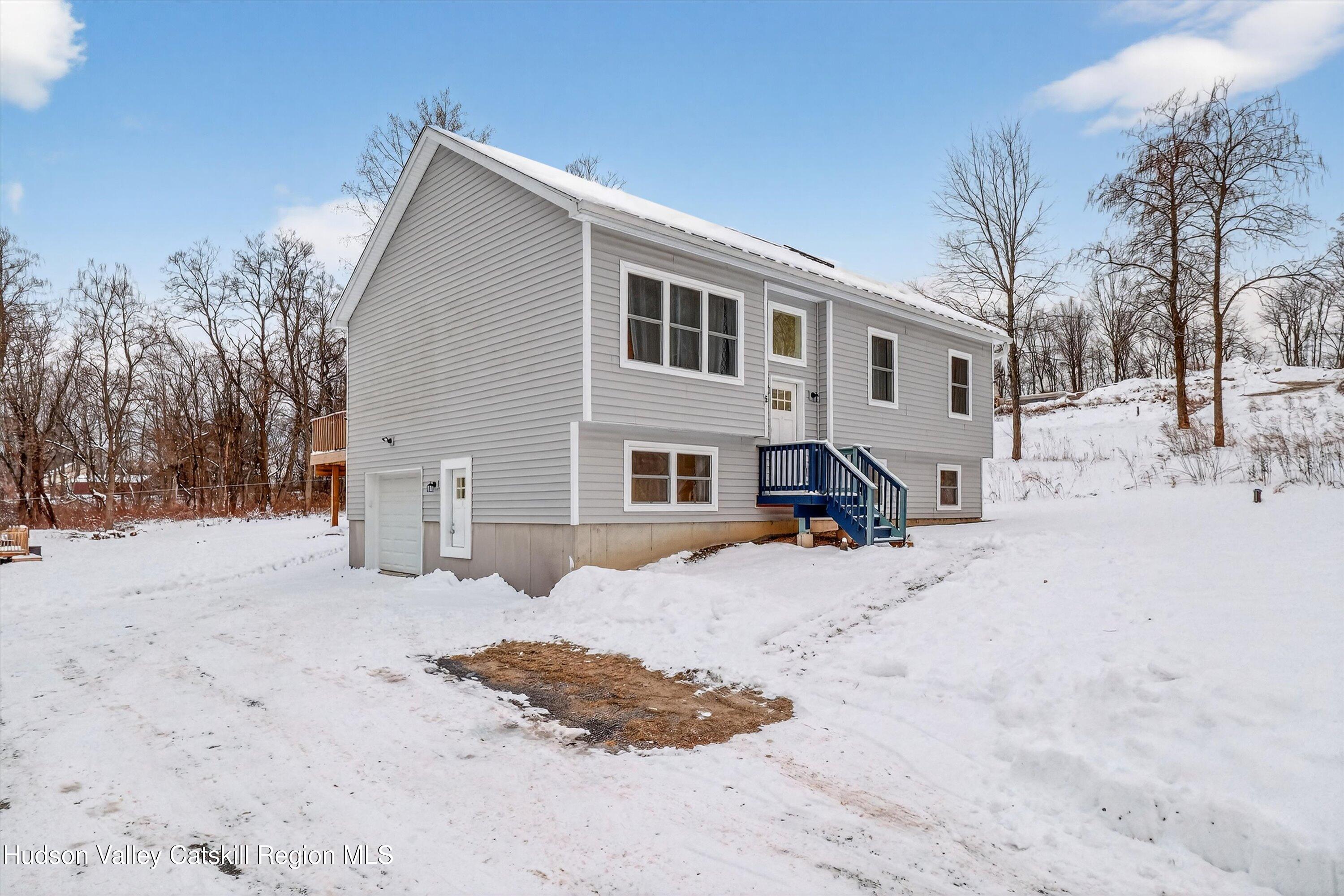 5 3rd Street Milton, NY 12547 - Photo 30 of 31 a front view of a house with a yard covered in snow