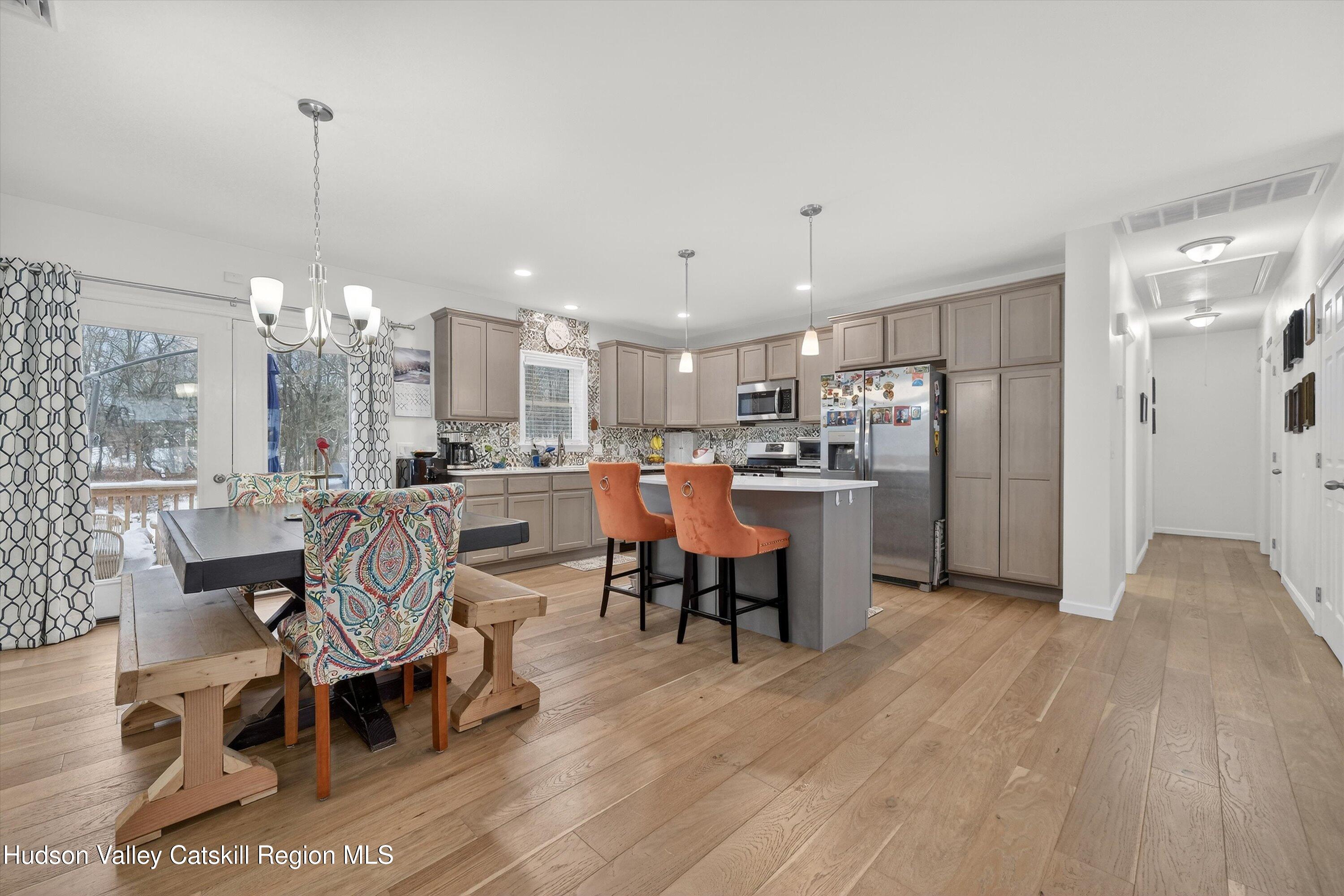 5 3rd Street Milton, NY 12547 - Photo 3 of 31 a view of a dining room and livingroom with furniture wooden floor a chandelier
