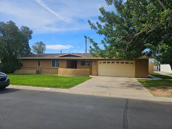 a front view of a house with a yard and a garage