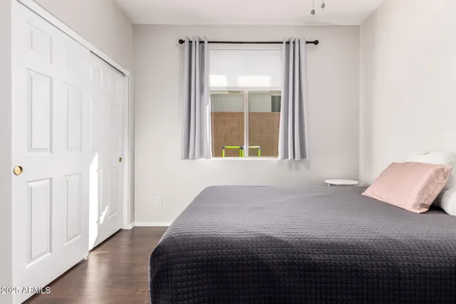 a bedroom with a bed and a window