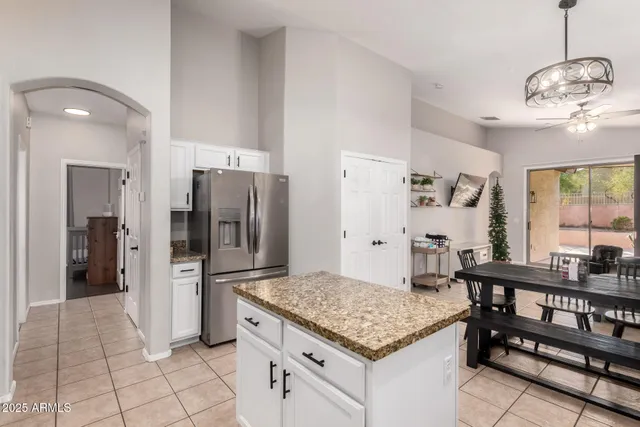 a kitchen with stainless steel appliances granite countertop a refrigerator and a sink