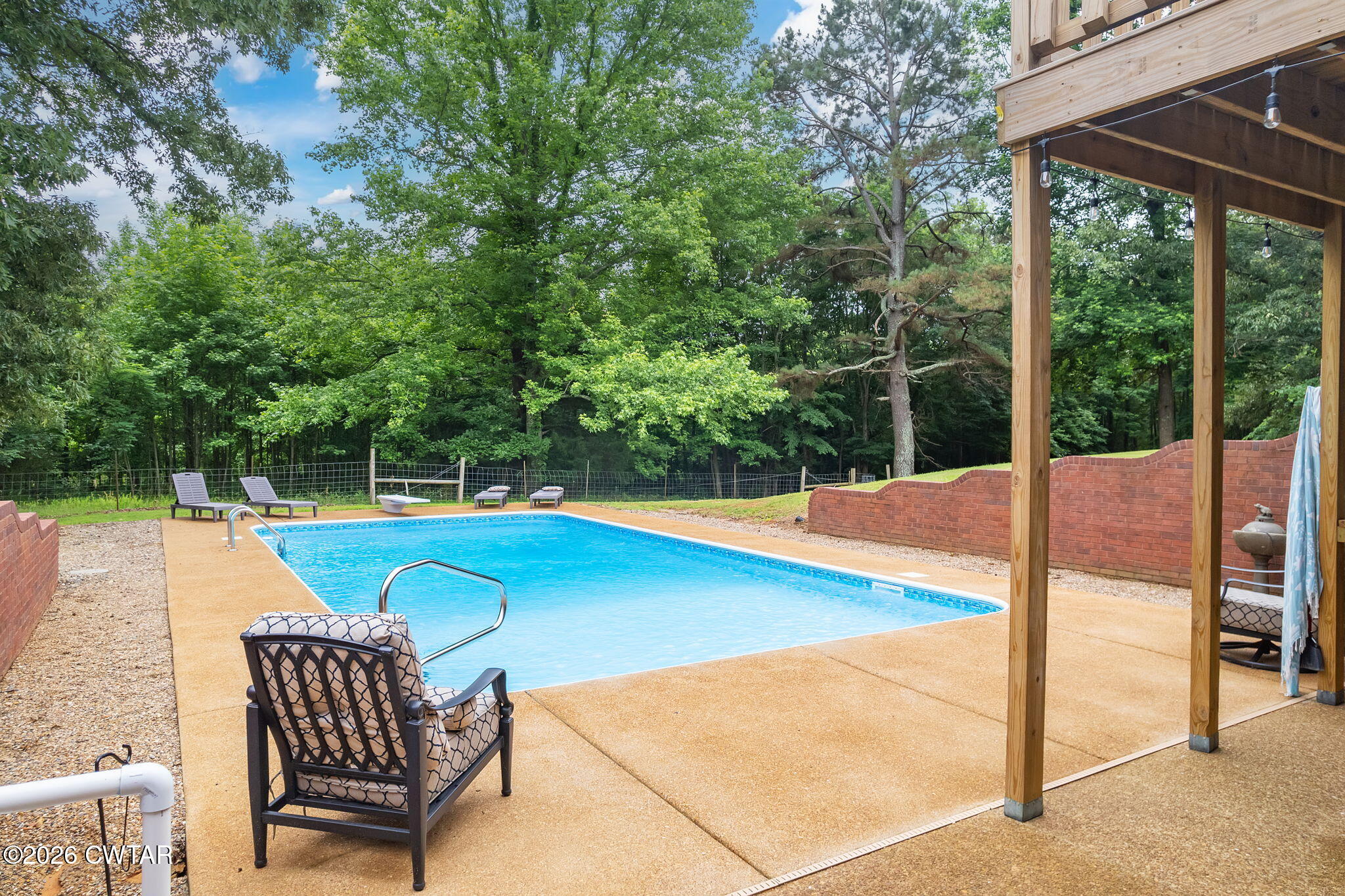 4320 Timberlake-Wildersville Road Lexington, TN 38351 - Photo 51 of 58 a view of a patio with a table chairs and a backyard