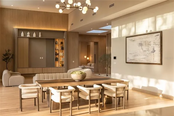 a living room with a dining table and chairs
