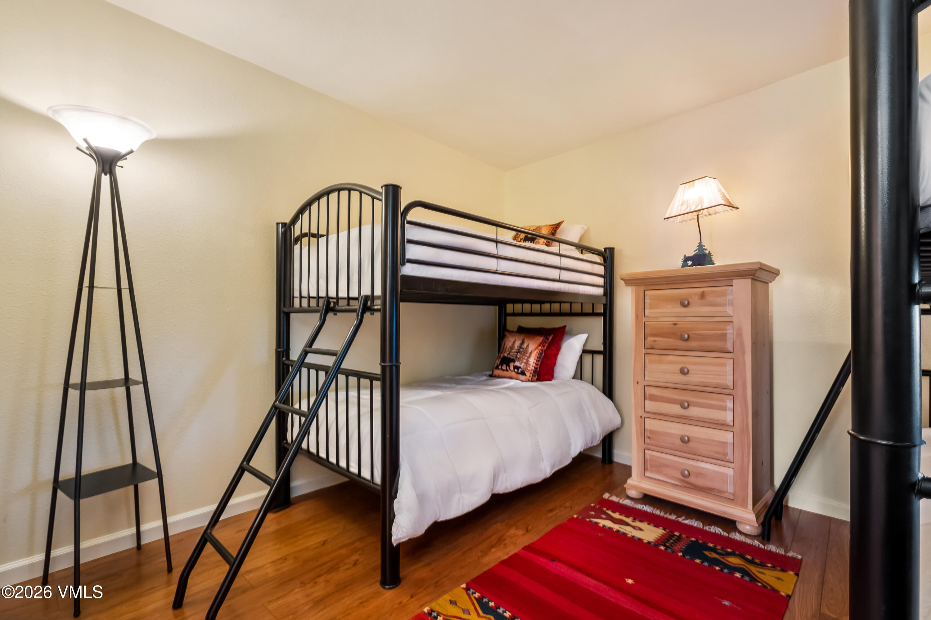 137 Benchmark Road, Unit 605 Avon, CO 81620 - Photo 23 of 30 a bedroom with a bed and a dresser