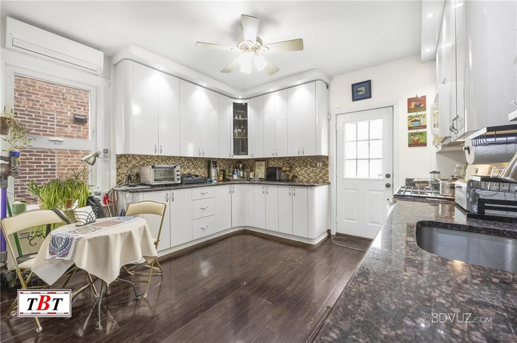 2515 Avenue R Brooklyn, NY 11229 - Photo 14 of 30 a large white kitchen with a large window a sink and appliances