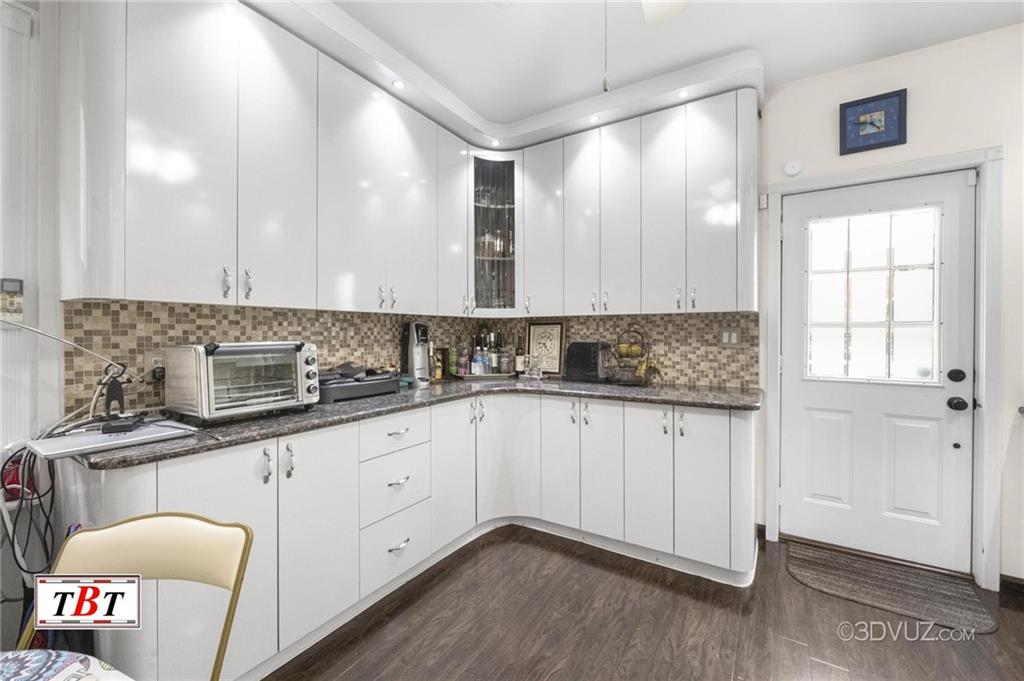 2515 Avenue R Brooklyn, NY 11229 - Photo 16 of 30 a kitchen with granite countertop a sink and cabinets