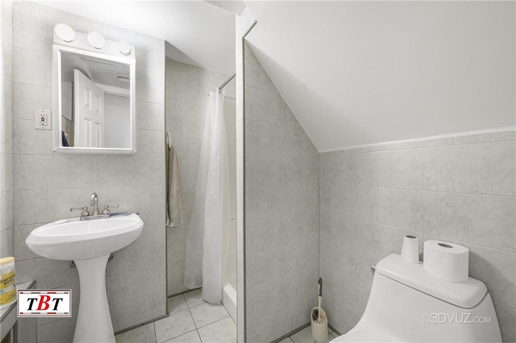 2515 Avenue R Brooklyn, NY 11229 - Photo 20 of 30 a bathroom with a sink toilet and mirror