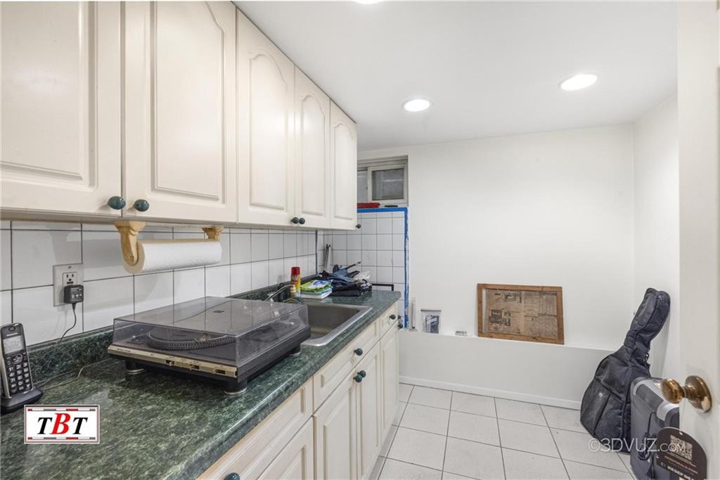 2515 Avenue R Brooklyn, NY 11229 - Photo 21 of 30 a kitchen with a sink a stove and cabinets