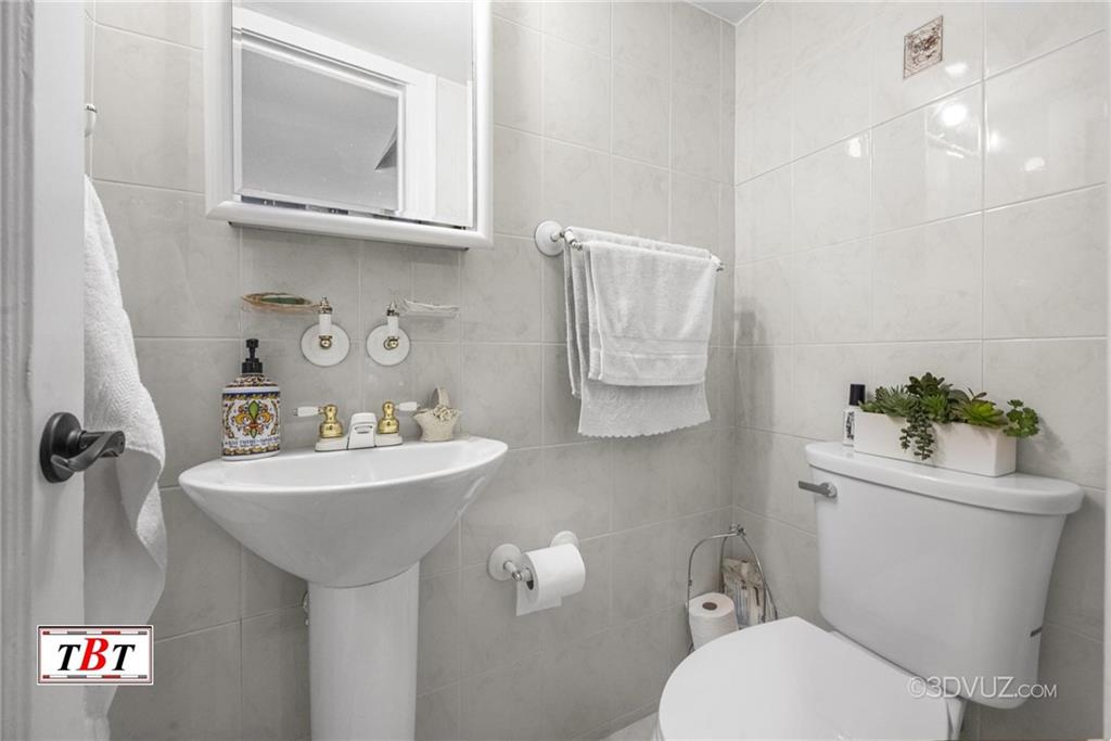 2515 Avenue R Brooklyn, NY 11229 - Photo 25 of 30 a bathroom with a toilet a sink and mirror