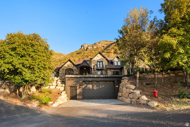 1141 South Oak Leaf Lane Springville, UT 84663 - Photo 18 of 147 Stone and stucco exterior residence featuring an oversized multi-car garage and a stone retaining wall