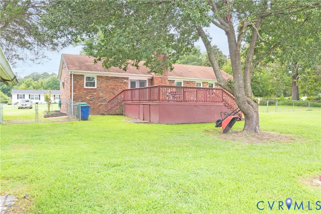2730 Kinvan Road Henrico, VA 23231 - Photo 6 of 37 Brick exterior with a large red-stained wooden dec