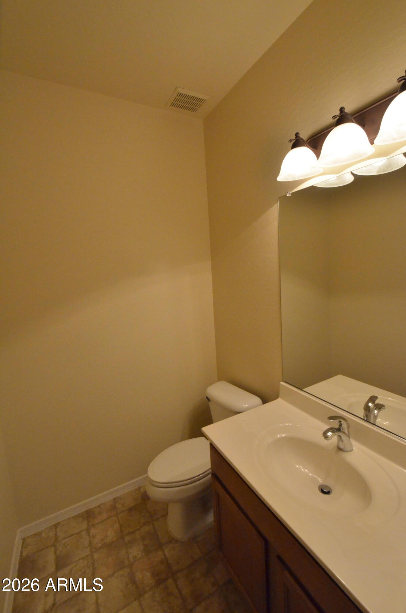3995 East Trigger Way Gilbert, AZ 85297 - Photo 12 of 23 a bathroom with a sink mirror and toilet