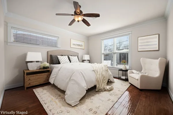 a bedroom with a large bed couch and a window