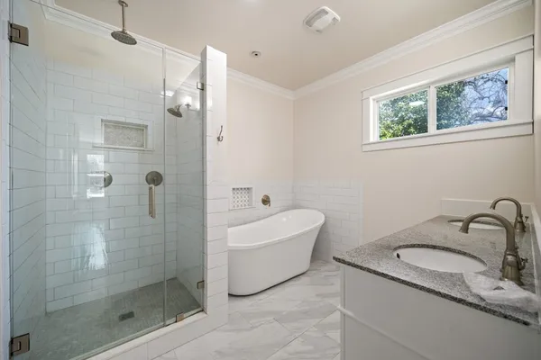 a bathroom with a sink mirror toilet and bathtub