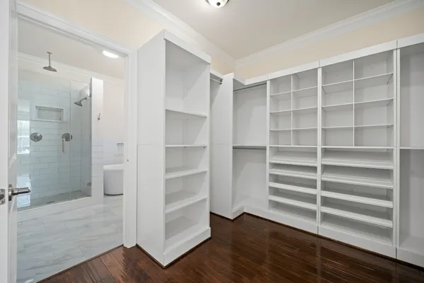 a view of walk in closet with empty racks