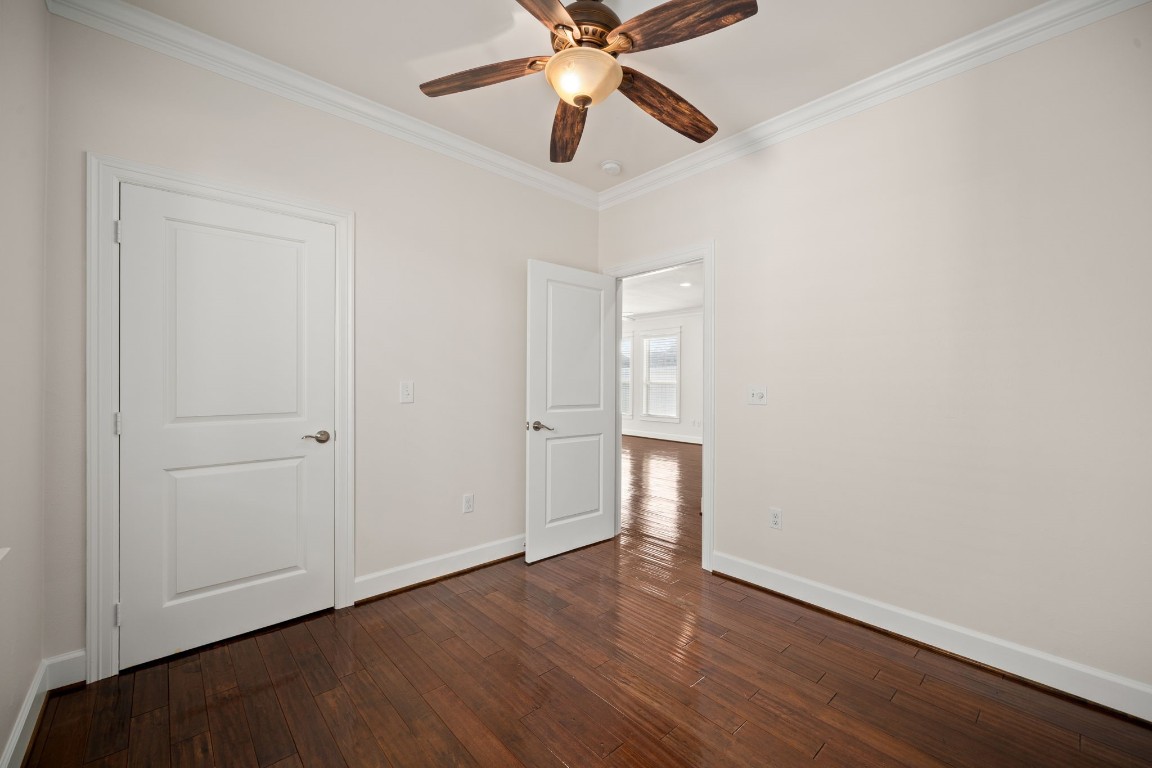 110 Kendall Street Houston, TX 77003 - Photo 18 of 36 an empty room with wooden floor ceiling fan and windows