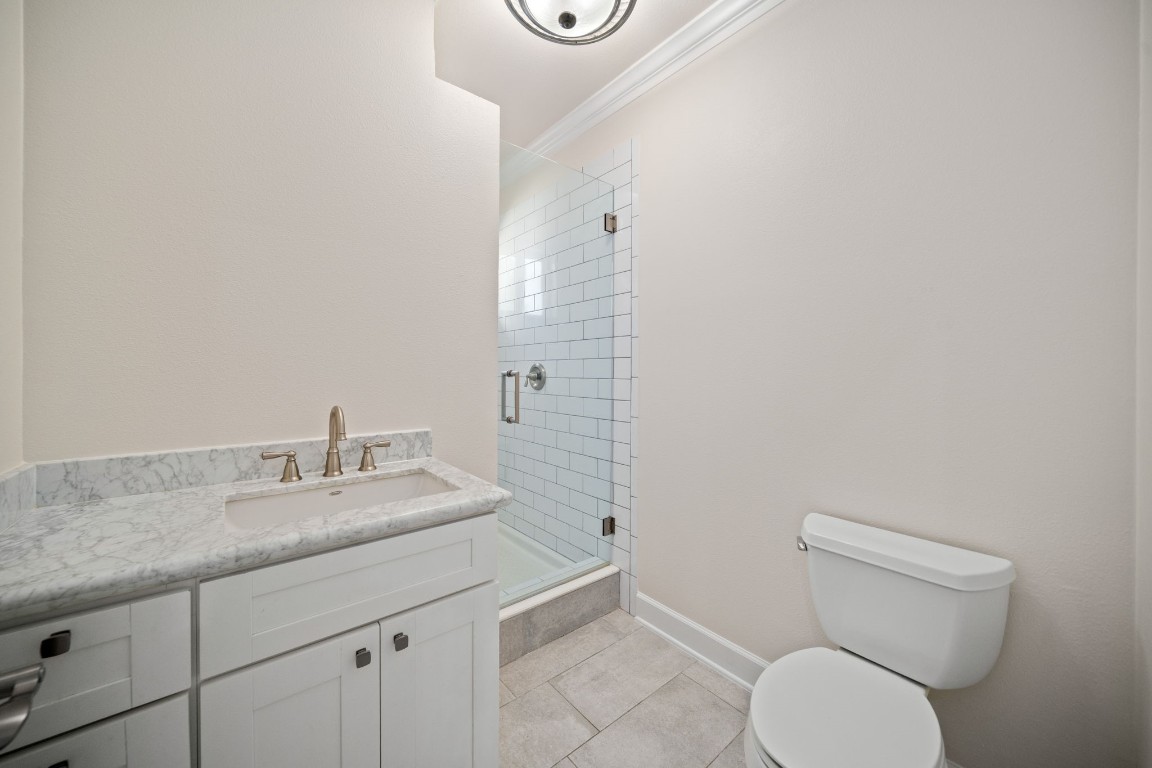 110 Kendall Street Houston, TX 77003 - Photo 19 of 36 a bathroom with a granite countertop toilet and a sink
