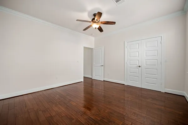 a view of an empty room with wooden floor