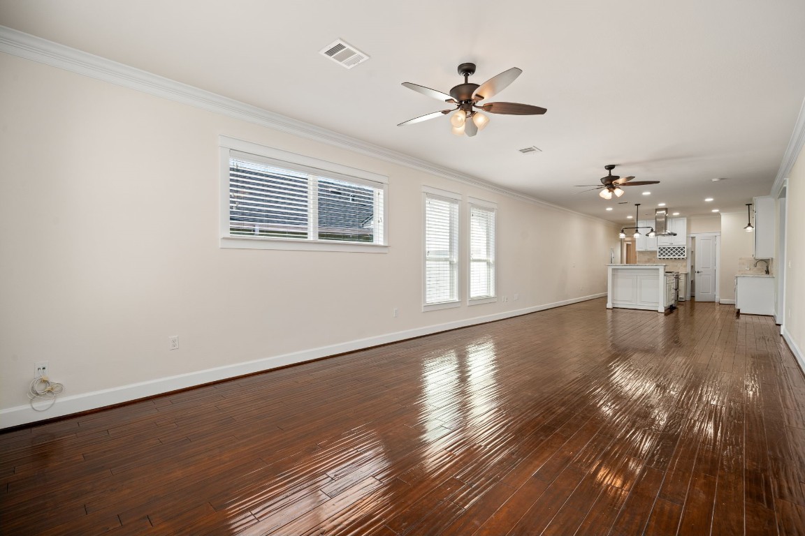 110 Kendall Street Houston, TX 77003 - Photo 5 of 36 a view of an empty room with wooden floor and a window