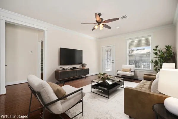 a living room with furniture a flat screen tv and a large window