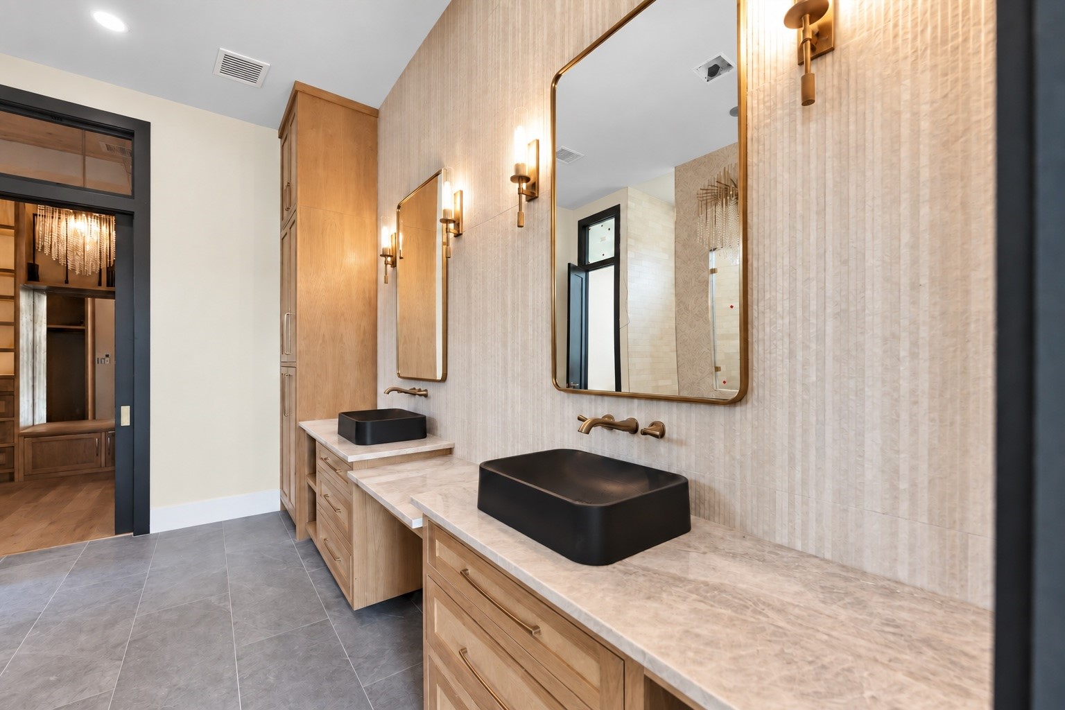 23701 Birch Grove Road Montgomery, TX 77316 - Photo 20 of 50 Elegant bathroom featuring dual vanities with sleek black vessel sinks, framed mirrors, and warm wood cabinetry, complemented by stylish wall sconces.