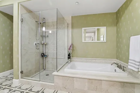 a bathroom with a bathtub and shower
