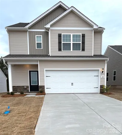 a view of a house with a parking area