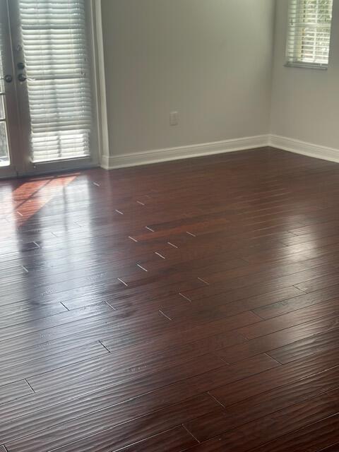 2502 North Dixie Highway, Unit 49 Lake Worth, FL 33460 - Photo 4 of 12 an empty room with wooden floor and windows