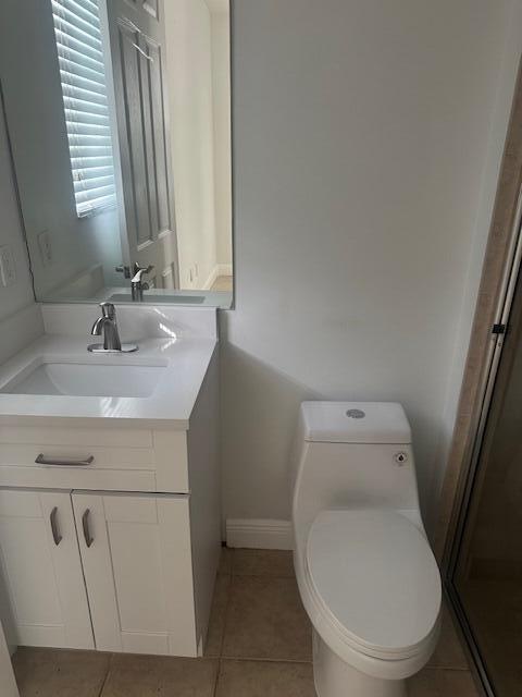 2502 North Dixie Highway, Unit 49 Lake Worth, FL 33460 - Photo 10 of 12 a bathroom with a toilet sink and mirror