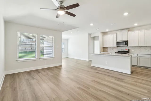 a view of kitchen with granite countertop cabinets and wooden floor