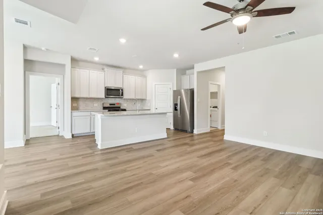 a view of a kitchen with a sink and a refrigerator