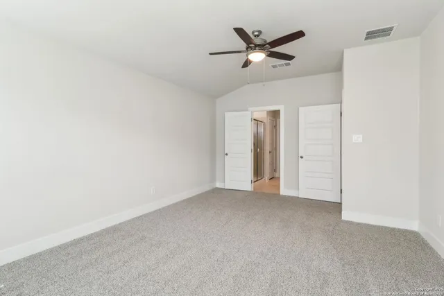 an empty room with a ceiling fan and a ceiling fan