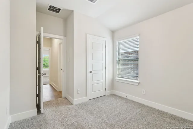 an empty room with closet area