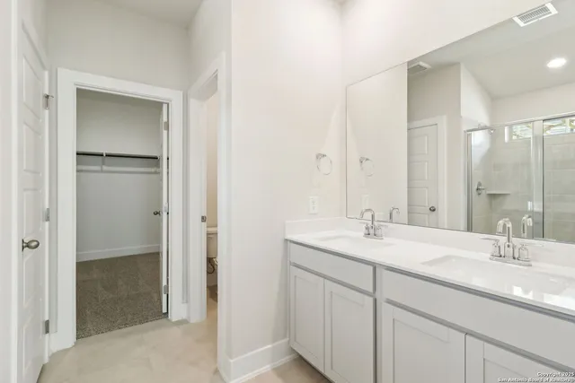 a bathroom with a sink double vanity and a mirror