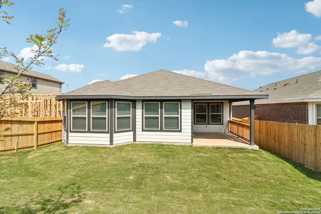 a view of a house with a backyard