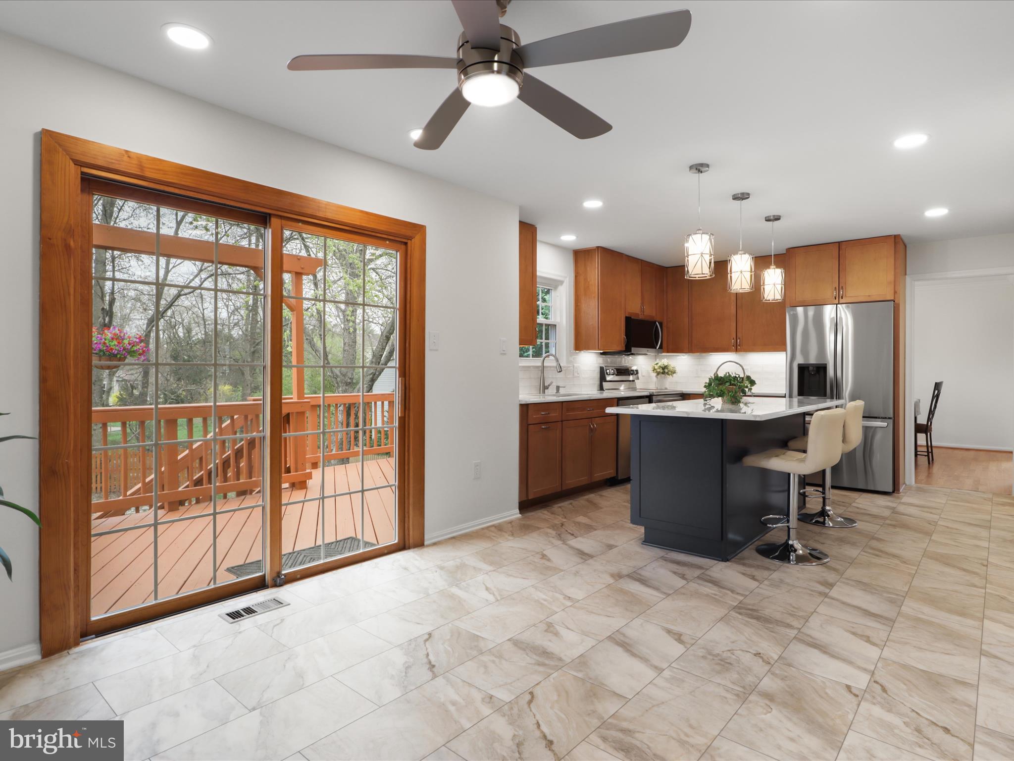 332 Silver Ridge Drive Sterling, VA 20164 - Photo 11 of 53 a open kitchen with stainless steel appliances granite countertop a refrigerator a sink a stove and white cabinets with wooden floor